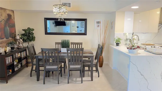 a view of a dining room with furniture and chandelier