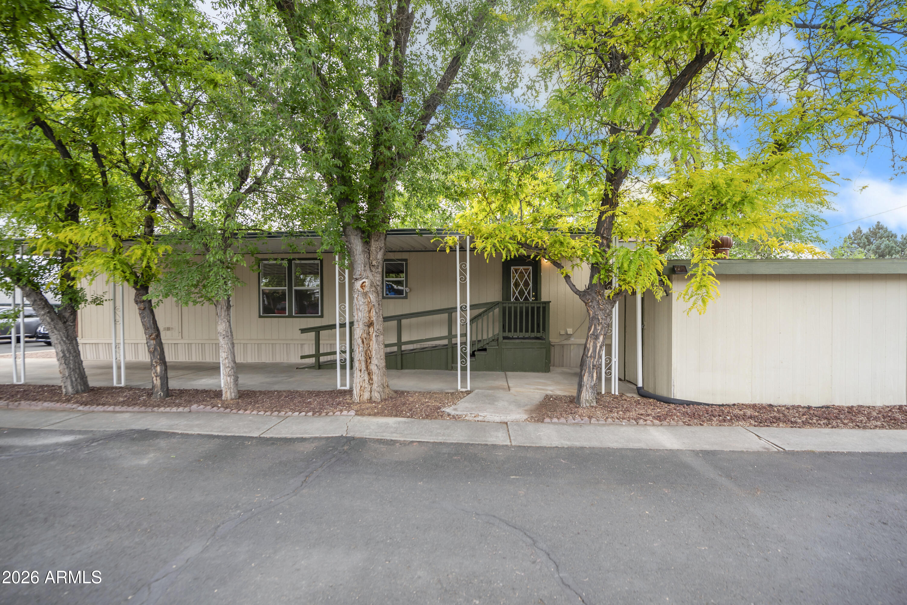 11250 East State Rte 69, Unit 1125 Dewey, AZ 86327 - Photo 41 of 45 a house with trees in front of it