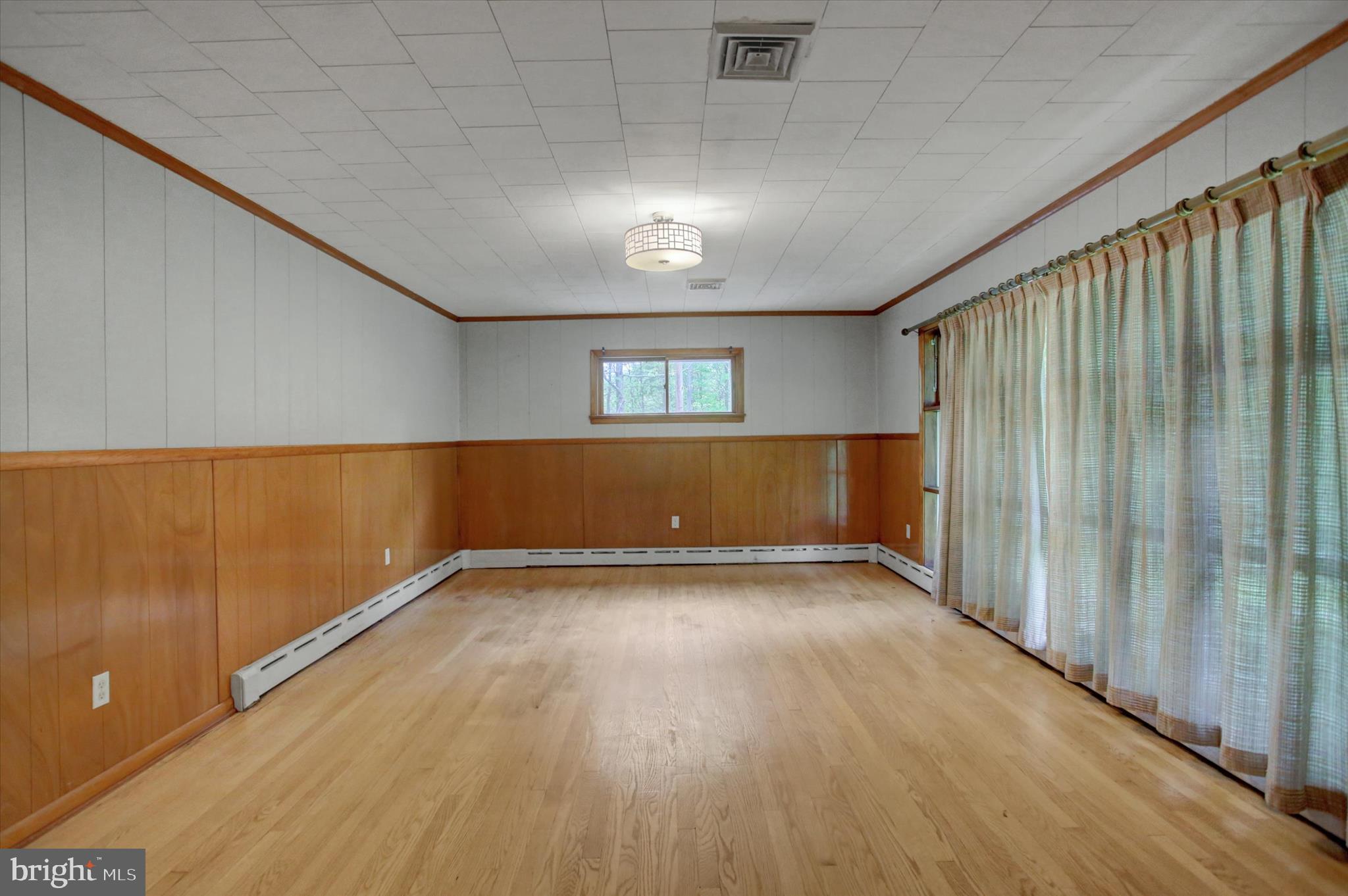 5156 Peach Orchard Road McConnellsburg, PA 17233 - Photo 8 of 34 an empty room with wooden floor and windows