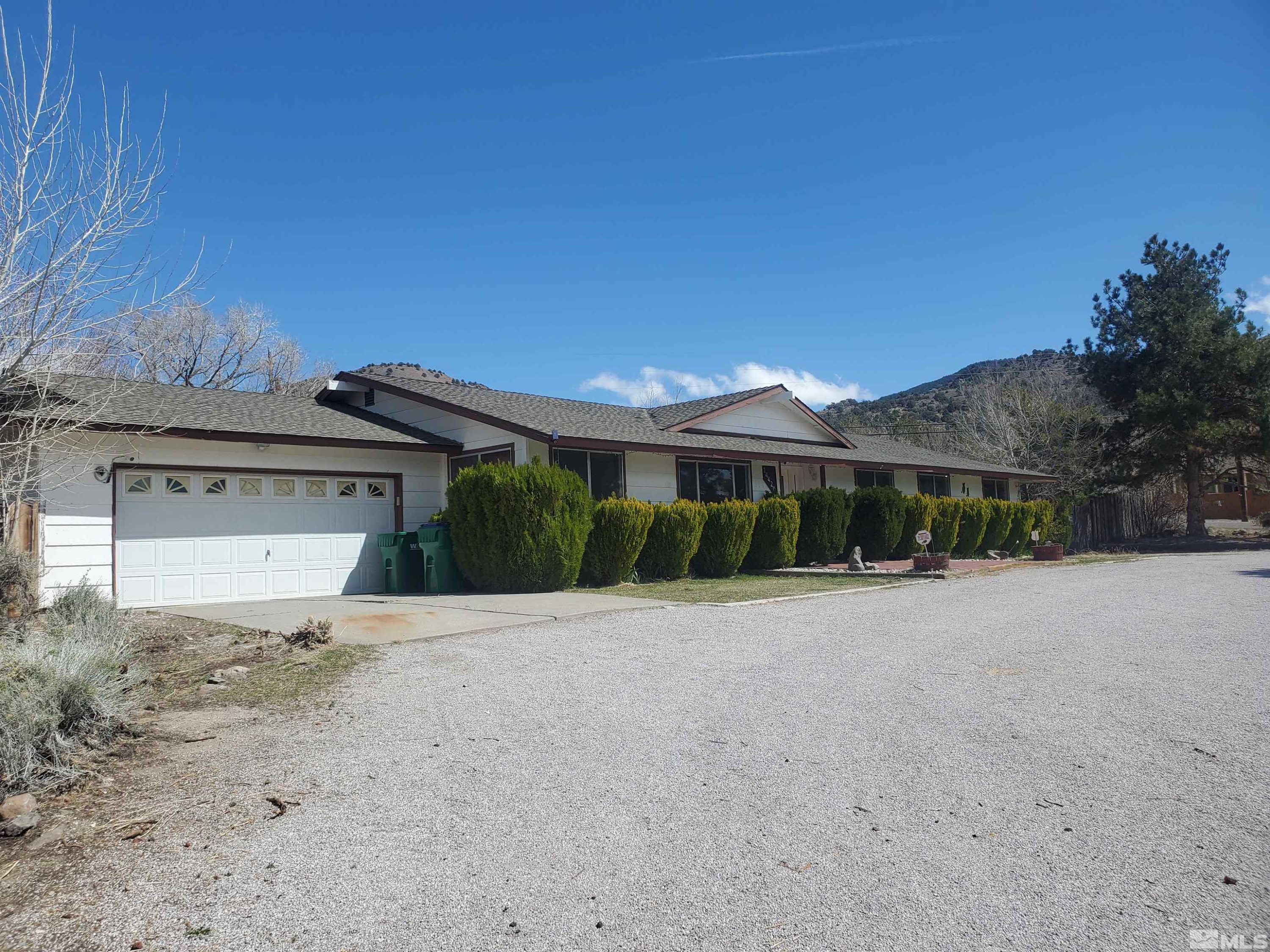 14420 Chamy Drive Reno, NV 89521 - Photo 3 of 21 a front view of a house with a yard and garage
