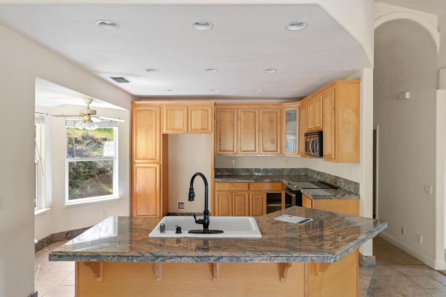 4410 Rossler Road Placerville, CA 95667 - Photo 14 of 35 a kitchen with kitchen island granite countertop a sink a counter top space and stainless steel appliances