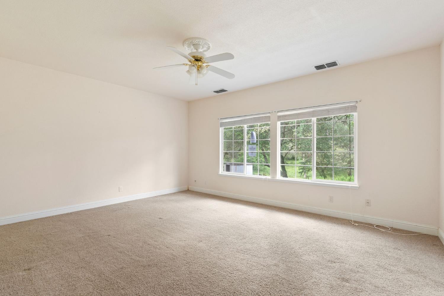 4410 Rossler Road Placerville, CA 95667 - Photo 20 of 35 an empty room with a window and a fan