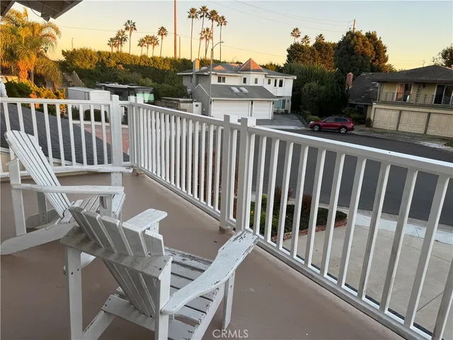 a view of a balcony with wooden fence