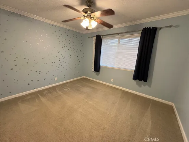 en empty room with windows and fan