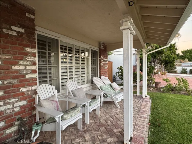 a view of a patio with a table chairs and backyard