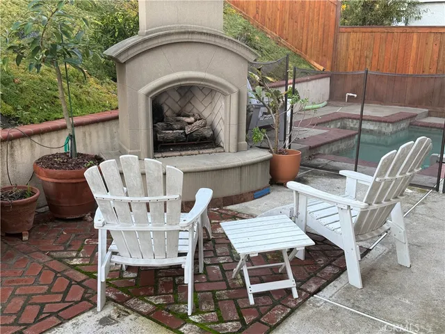 a view of a patio with table and chairs with wooden floor and fence