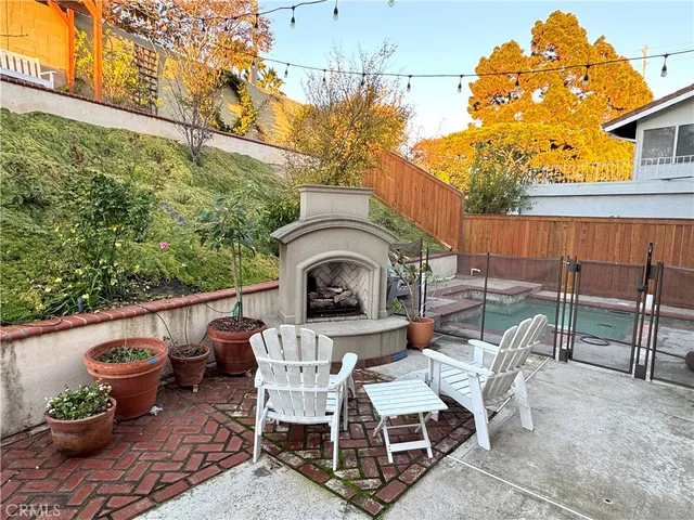 a view of a chairs and table in the back yard of the house