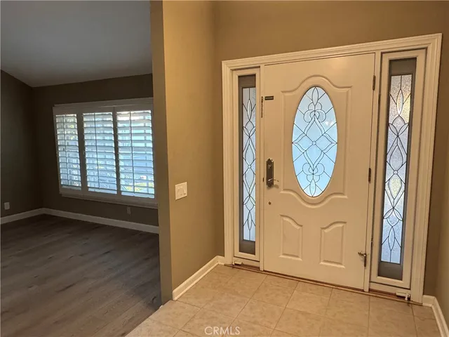 an empty room with wooden floor and entrance