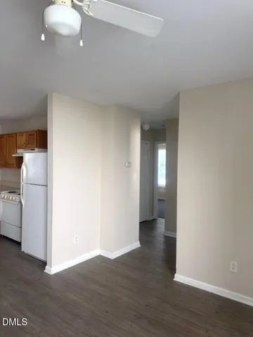 a view of a room with wooden floor