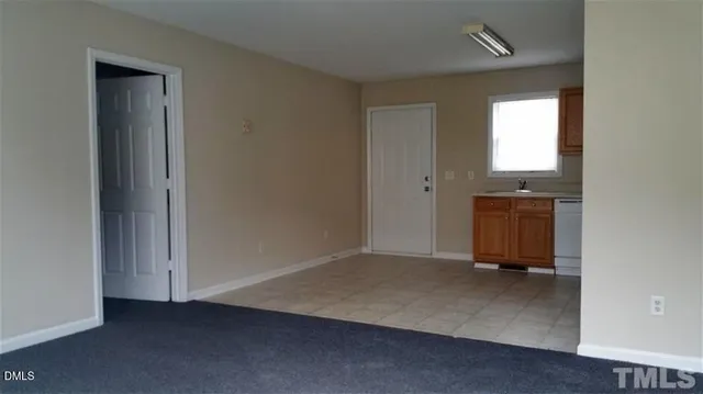 an empty room with a window and a ceiling fan
