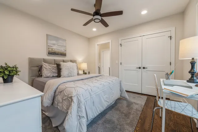 a bedroom with a bed and a chandelier