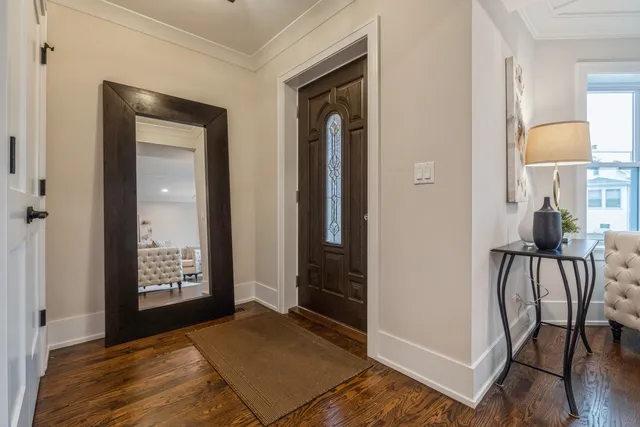 a living room with furniture a large window and a rug