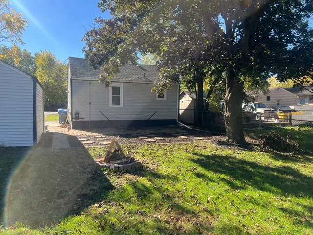 a view of a backyard with large trees