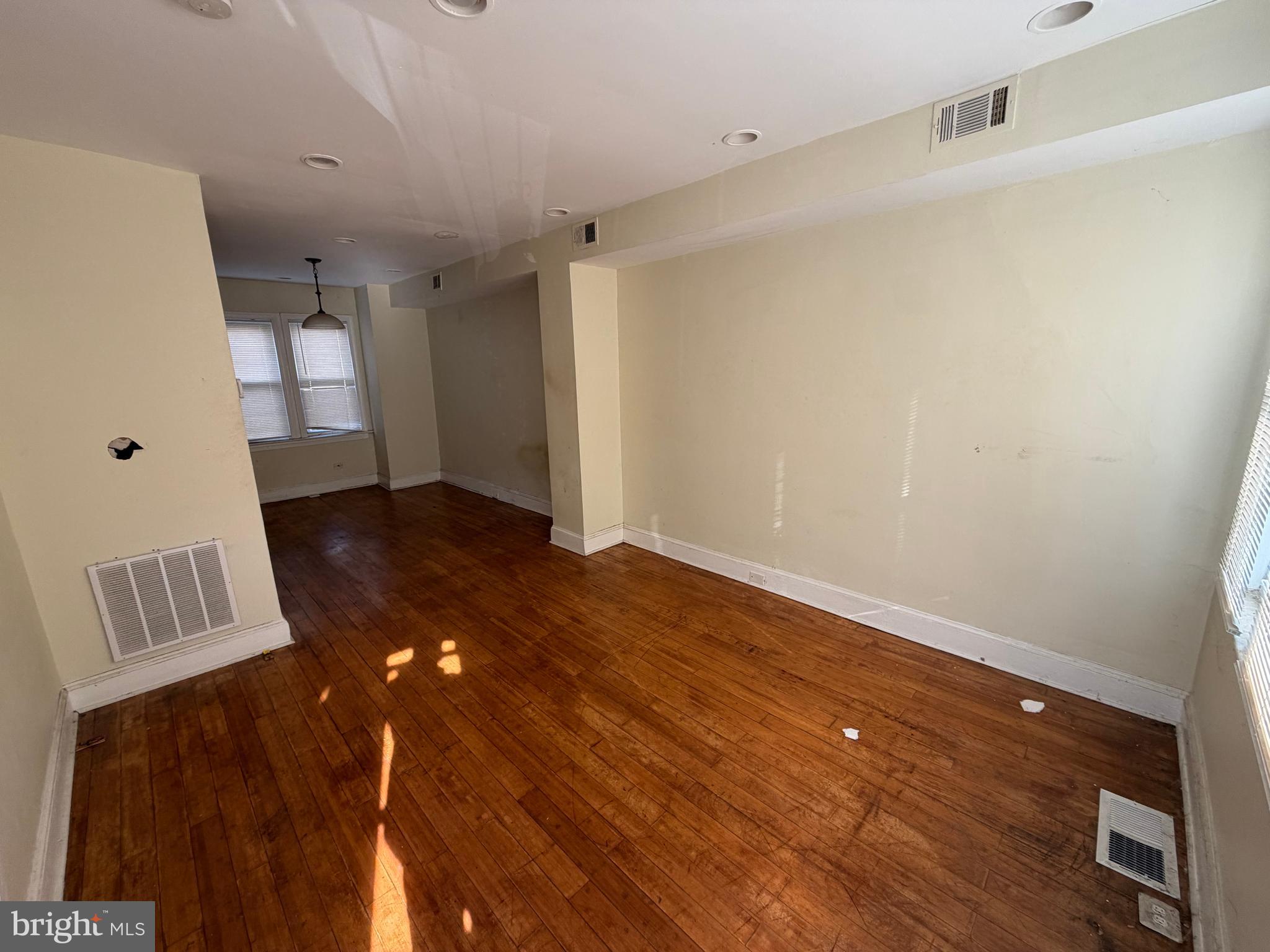 130 16th Street Northeast Washington, DC 20002 - Photo 3 of 24 a view of an empty room with wooden floor and a window