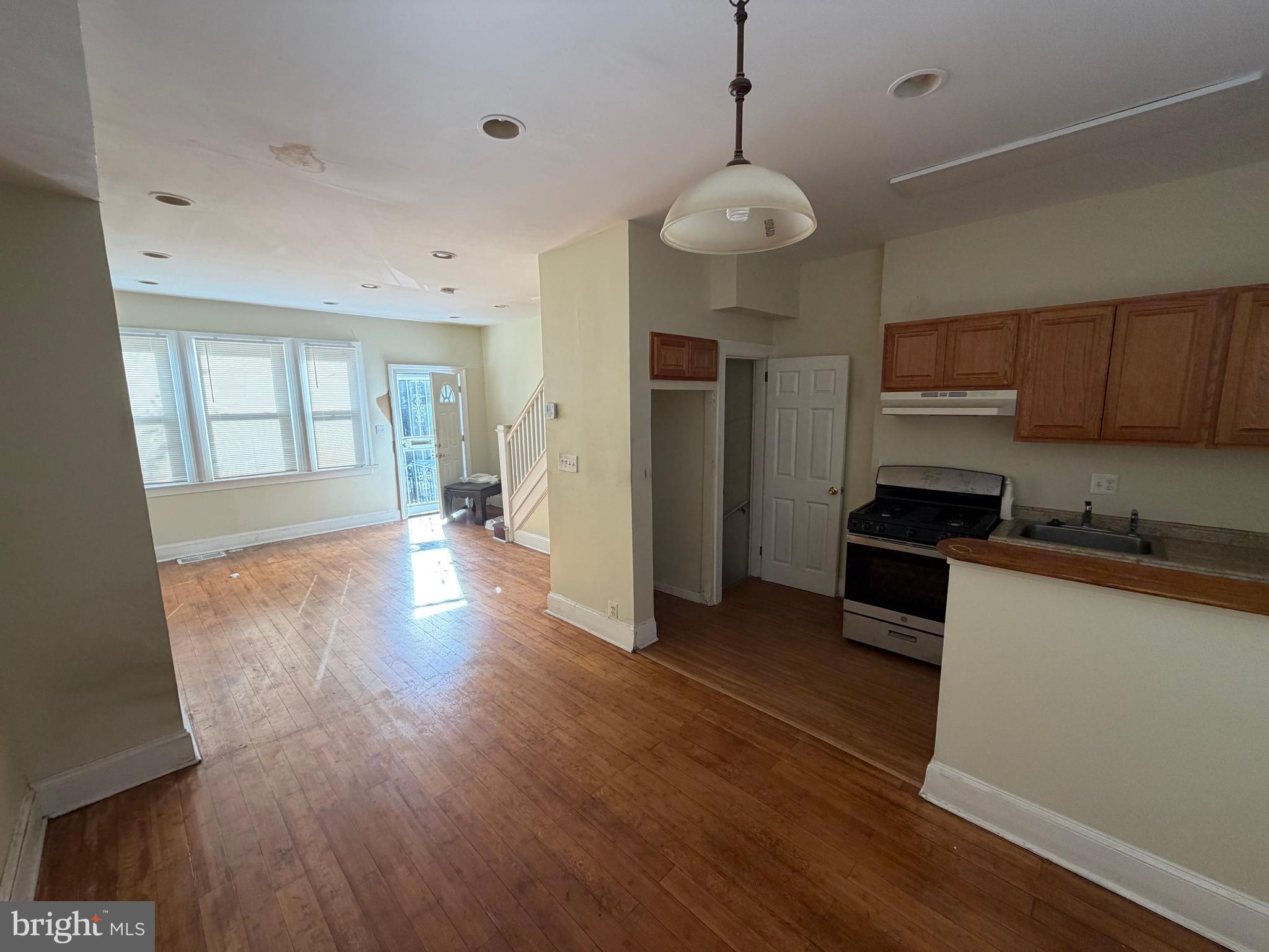 130 16th Street Northeast Washington, DC 20002 - Photo 4 of 24 a open kitchen with stainless steel appliances granite countertop a stove and wooden floor