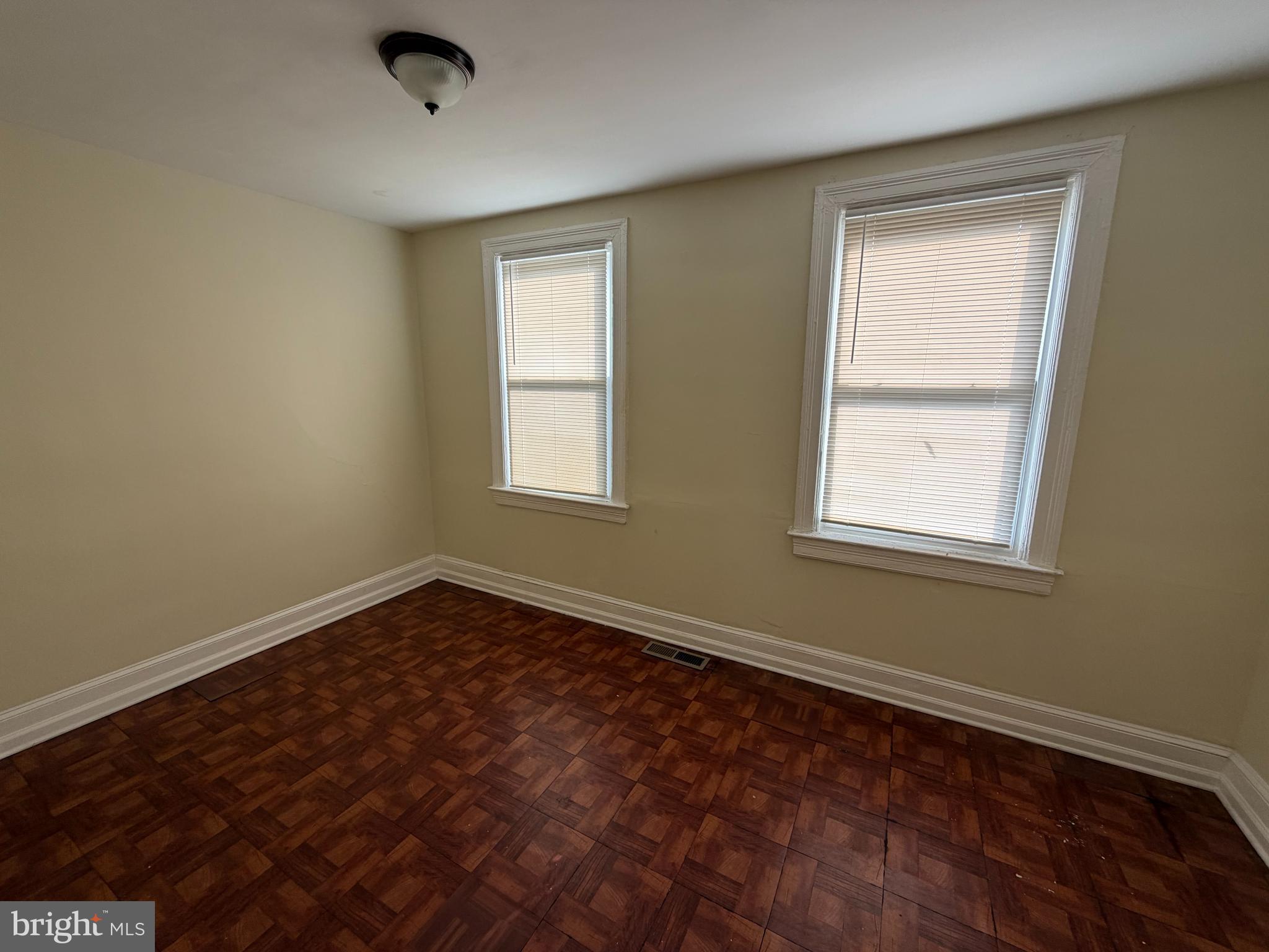 130 16th Street Northeast Washington, DC 20002 - Photo 9 of 24 a view of an empty room with wooden floor and a window
