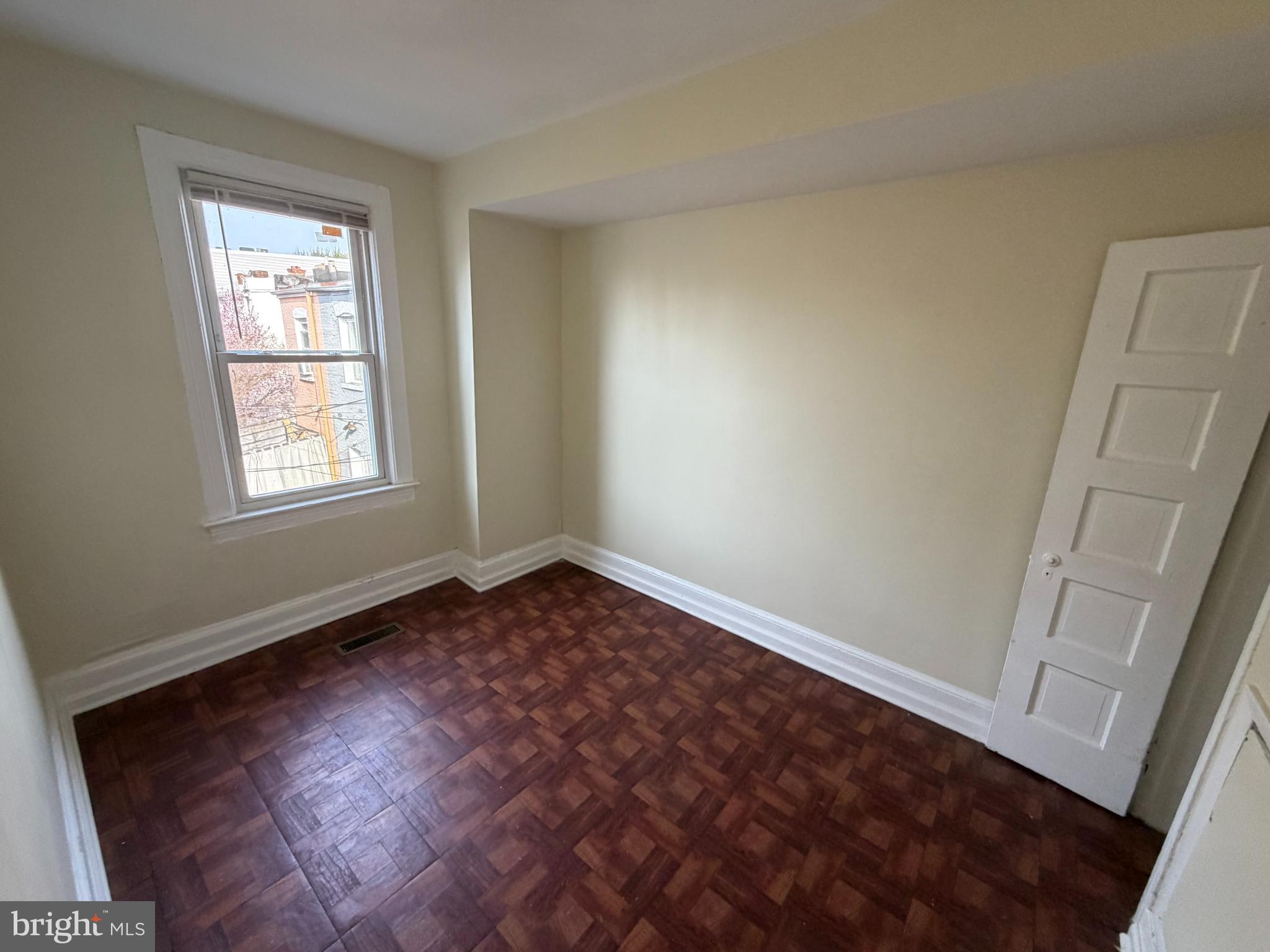 130 16th Street Northeast Washington, DC 20002 - Photo 10 of 24 an empty room with wooden floor and windows