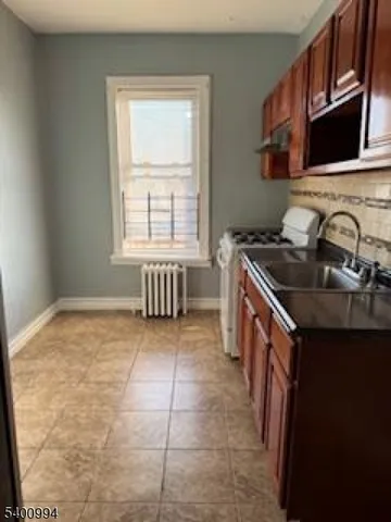 a kitchen with a sink stove and cabinets