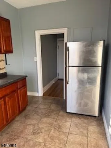 a view of kitchen with furniture and refrigerator