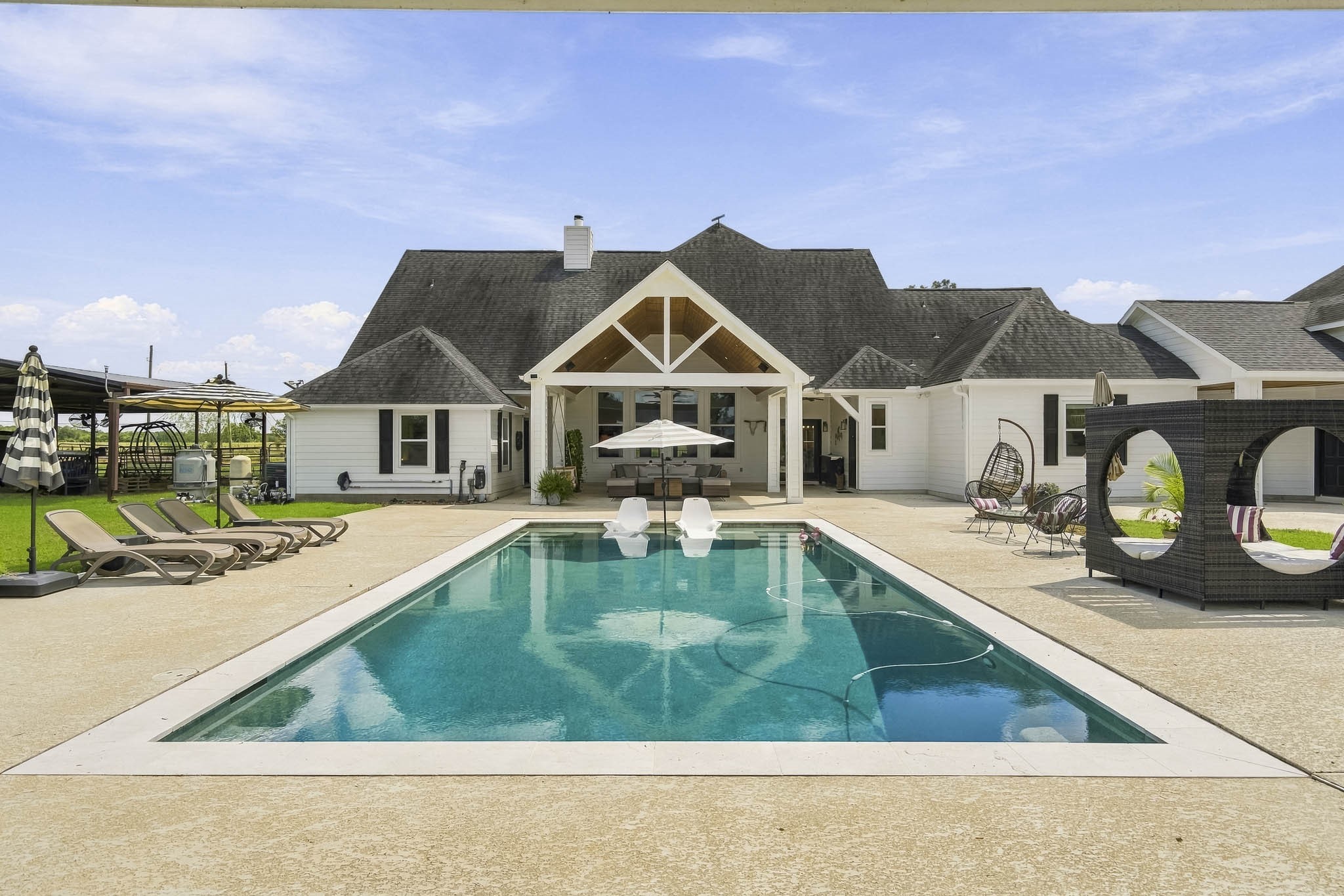3103 Brundrett Road Wallis, TX 77485 - Photo 35 of 45 This sleek and stylish Pool serves as the crown jewel of the Backyard oasis, thoughtfully designed for both relaxation and recreation. Featuring a spacious tanning ledge, built-in umbrella, and slip-resistant decking, it offers the perfect place to cool off on warm Texas afternoons or lounge poolside in comfort. With its clean lines and resort-inspired design, this stunning retreat is destined to become your favorite gathering spot.