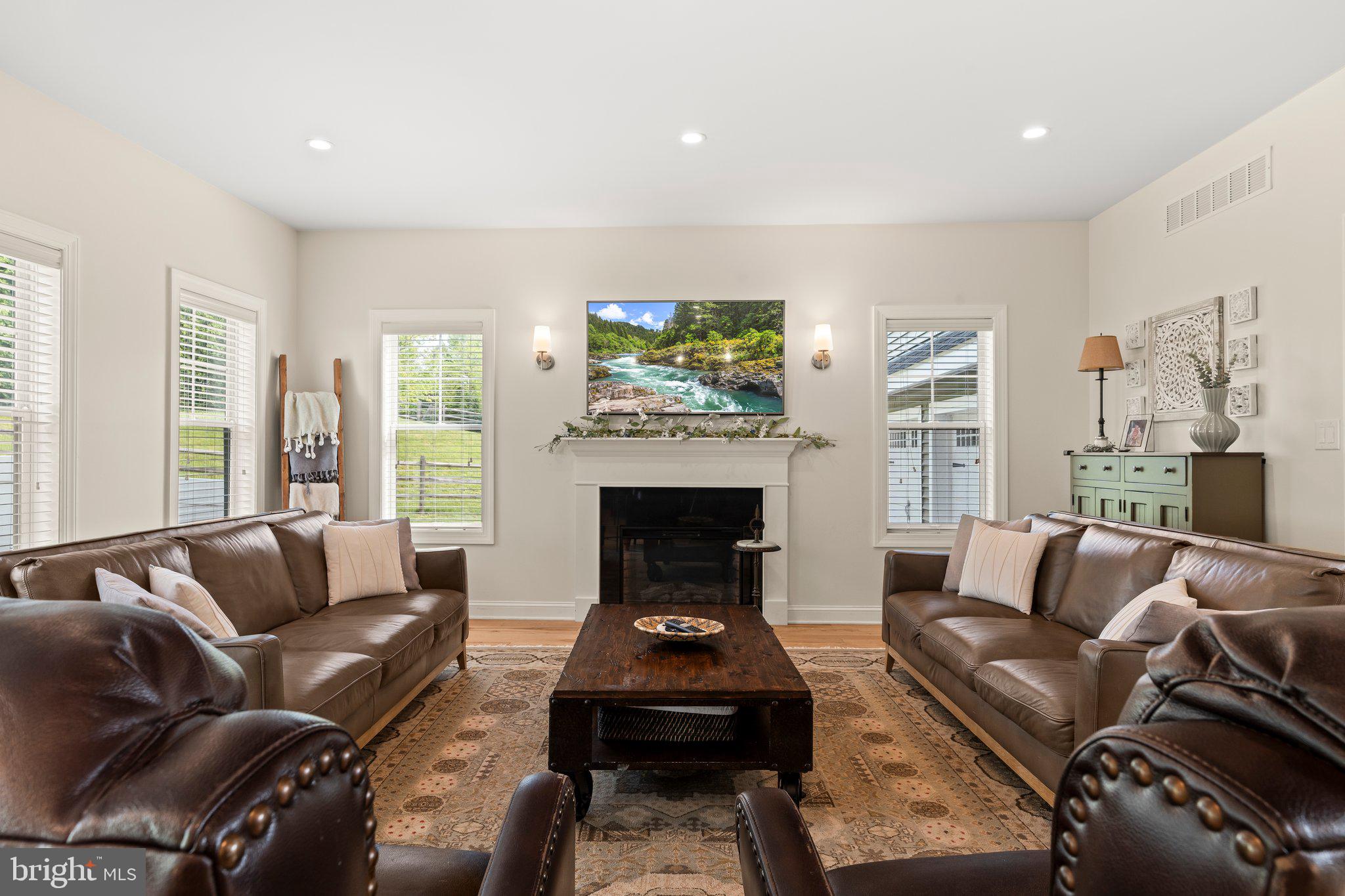 1413 Cortez Road Blue Bell, PA 19422 - Photo 12 of 66 a living room with furniture a fireplace and a flat screen tv
