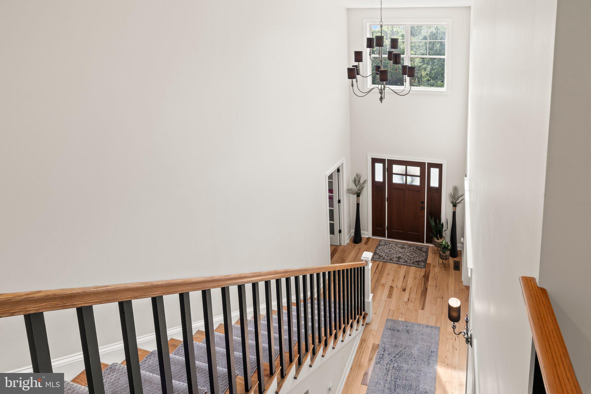 1413 Cortez Road Blue Bell, PA 19422 - Photo 25 of 66 a view of a hallway with wooden floor and staircase