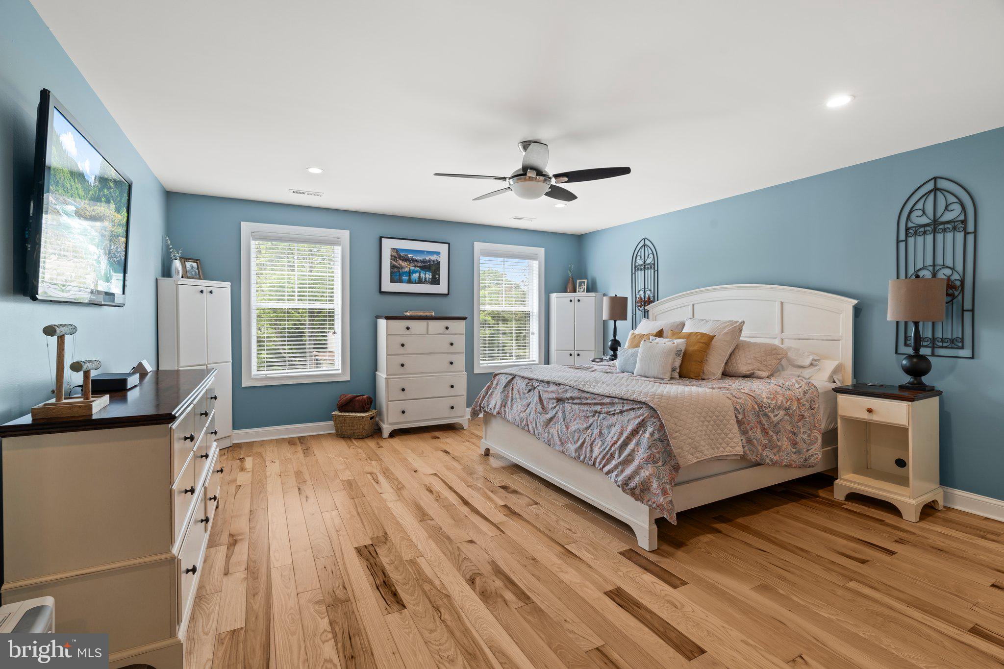 1413 Cortez Road Blue Bell, PA 19422 - Photo 28 of 66 a bedroom with a large bed and a chandelier