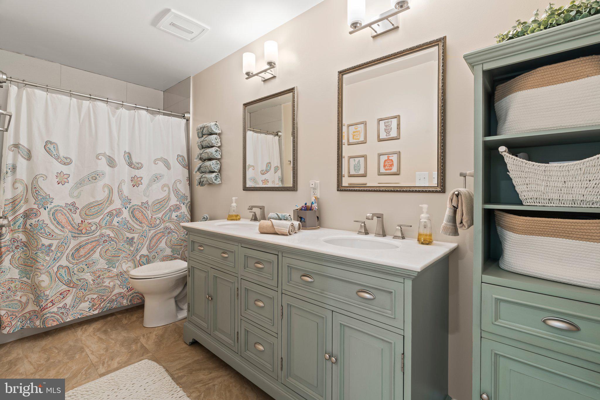 1413 Cortez Road Blue Bell, PA 19422 - Photo 40 of 66 a spacious bathroom with a double vanity sink toilet and a mirror
