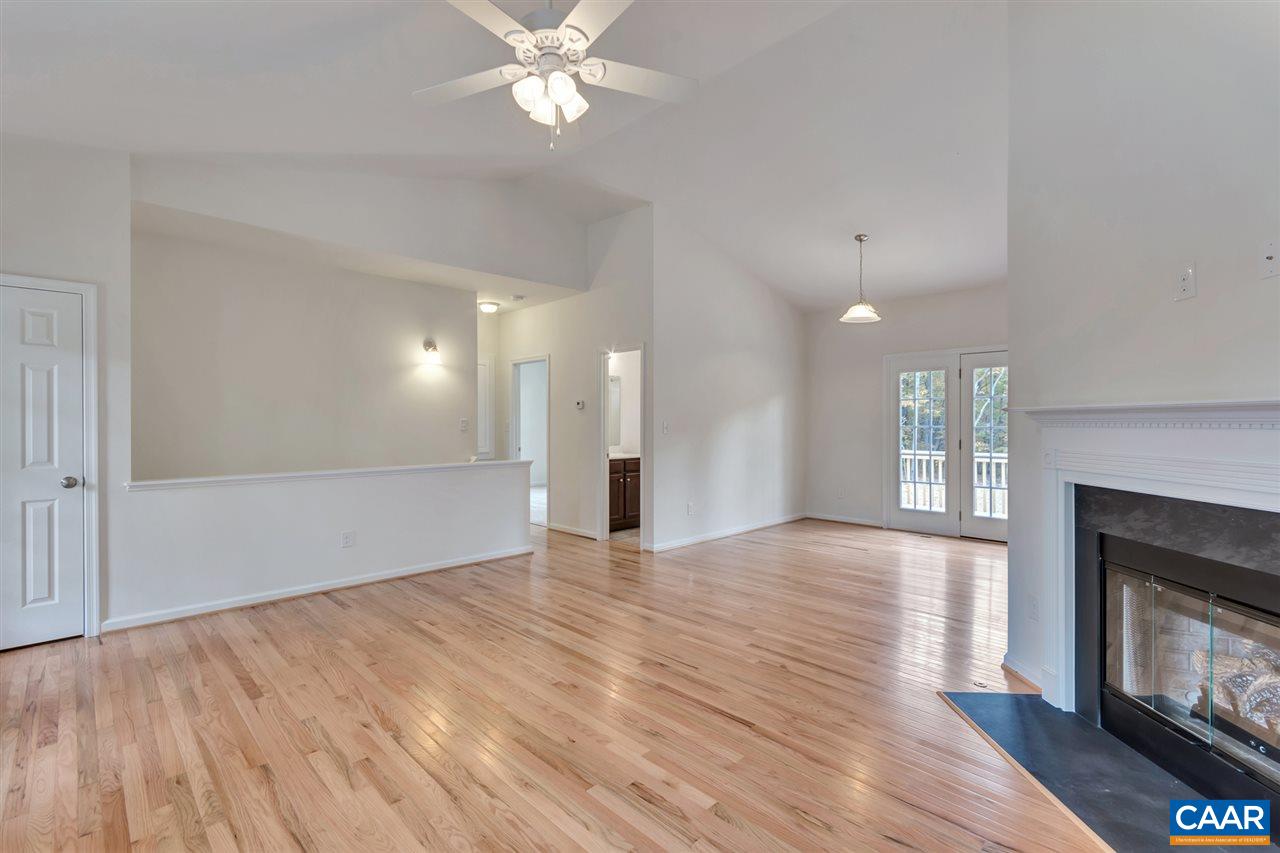 2235 Swift Run Road Ruckersville, VA 22968 - Photo 3 of 21 a view of an empty room with wooden floor and a fireplace