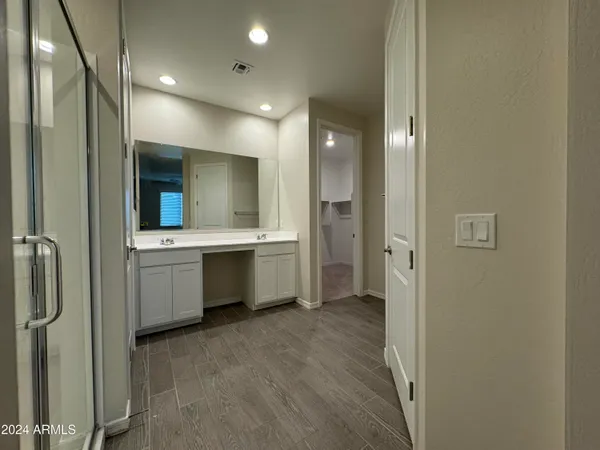 a bathroom with a double vanity sink mirror and shower
