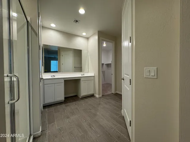 a bathroom with a double vanity sink mirror and shower