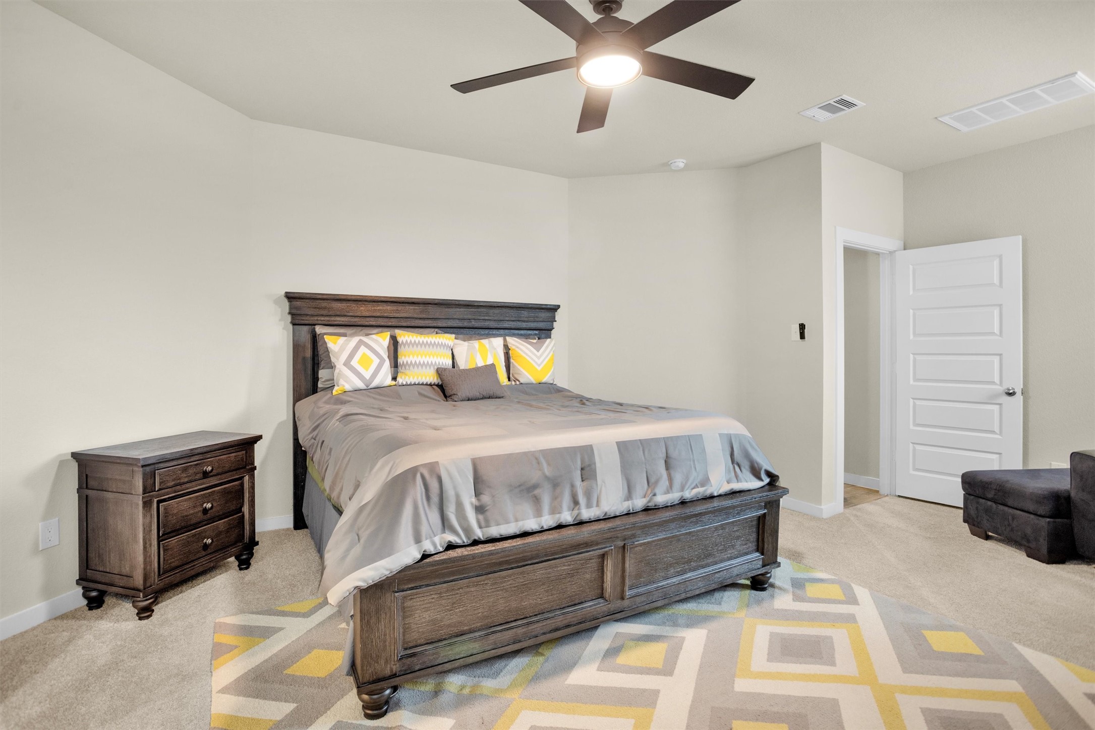 2210 Reed Cave Ln Spring Spring, TX 77386 - Photo 20 of 40 a bedroom with a bed and a chandelier