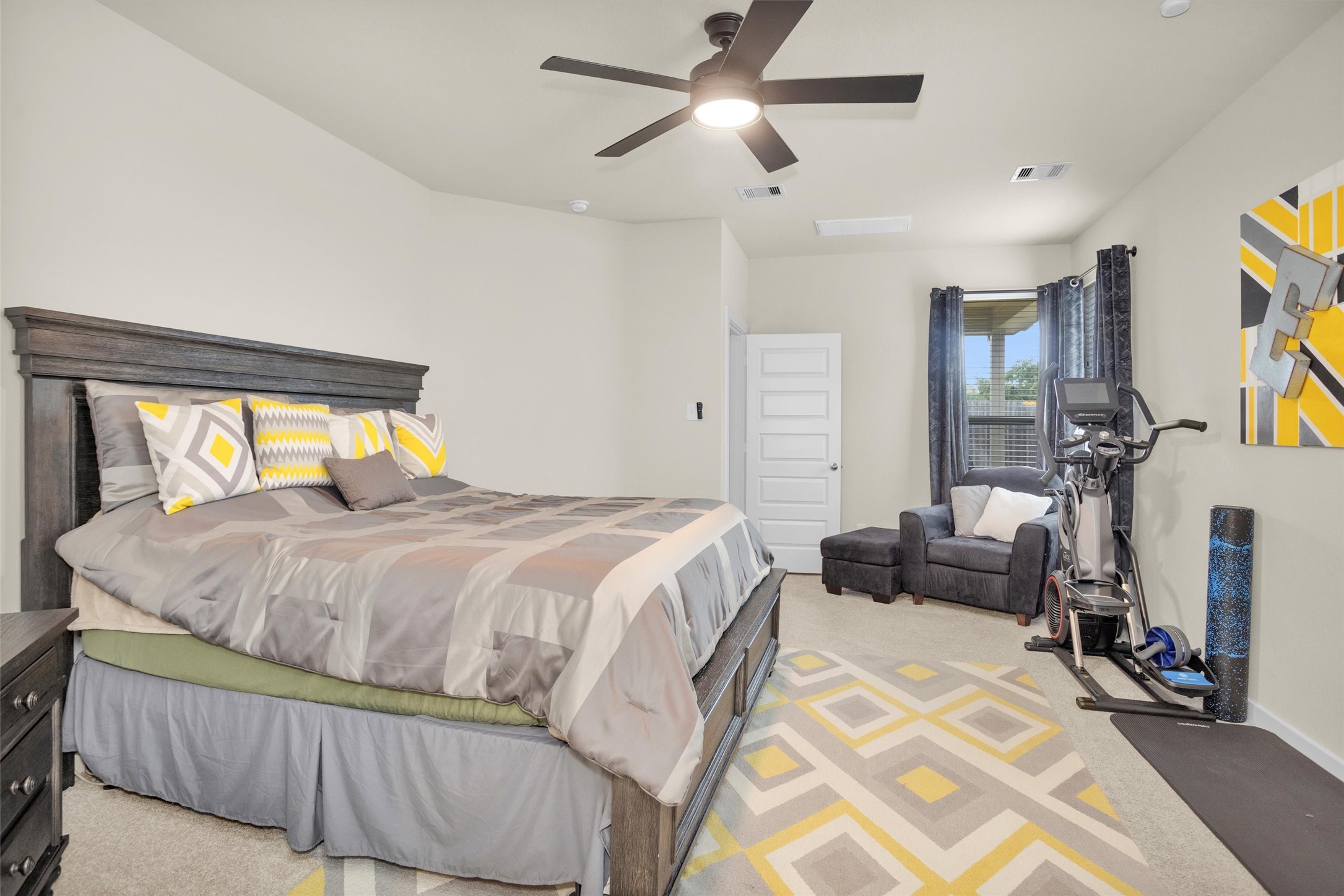 2210 Reed Cave Ln Spring Spring, TX 77386 - Photo 21 of 40 a bedroom with a bed a couch and a chandelier