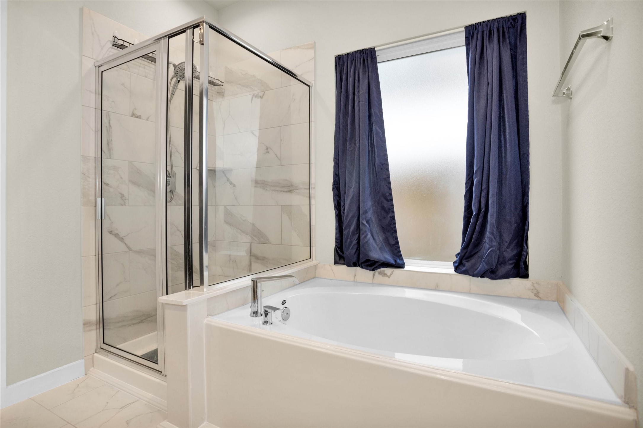 2210 Reed Cave Ln Spring Spring, TX 77386 - Photo 24 of 40 a bathroom with a bathtub and a shower