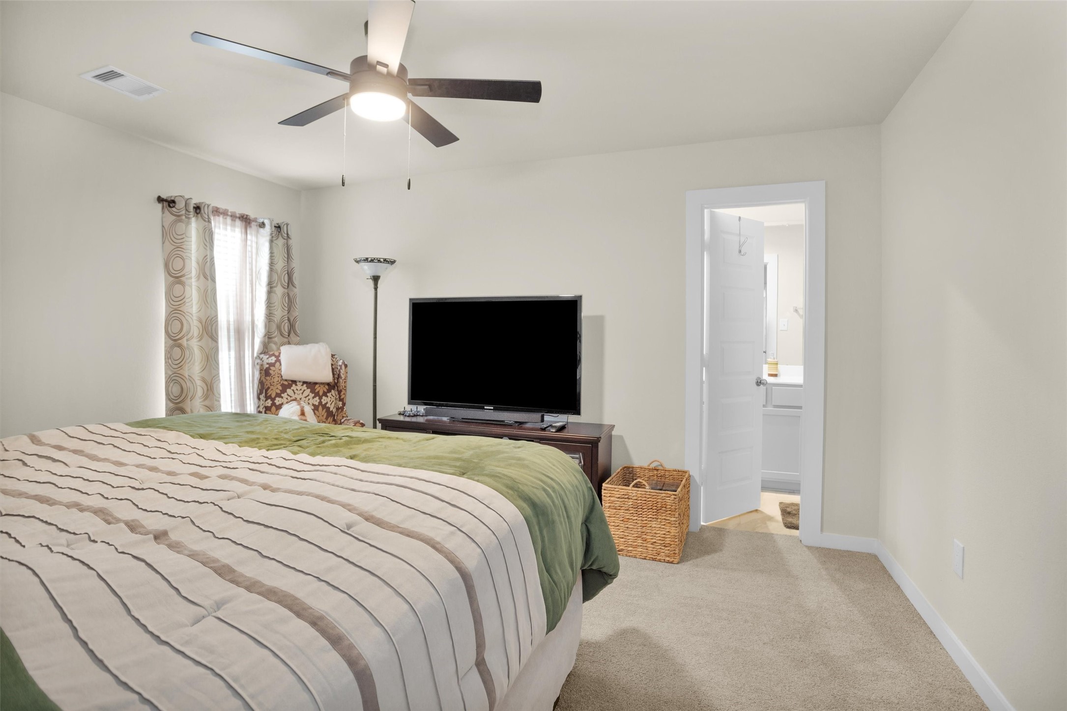 2210 Reed Cave Ln Spring Spring, TX 77386 - Photo 28 of 40 a bedroom with a bed and a flat screen tv