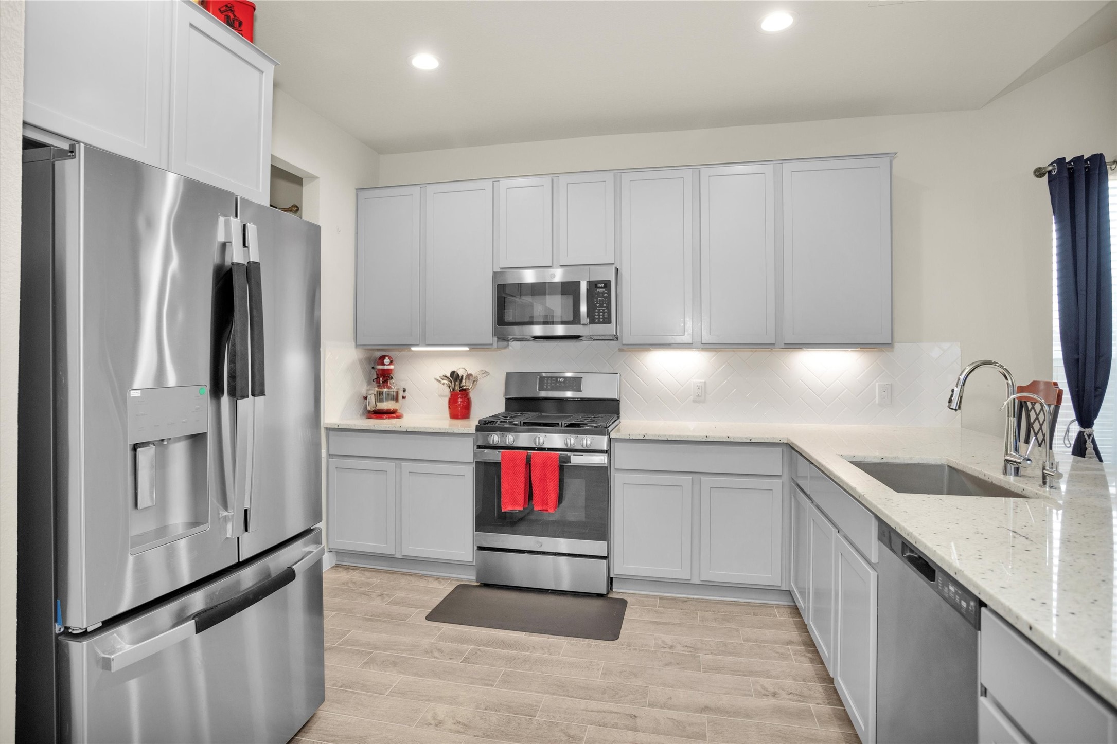 2210 Reed Cave Ln Spring Spring, TX 77386 - Photo 8 of 40 a kitchen with granite countertop a refrigerator and a sink