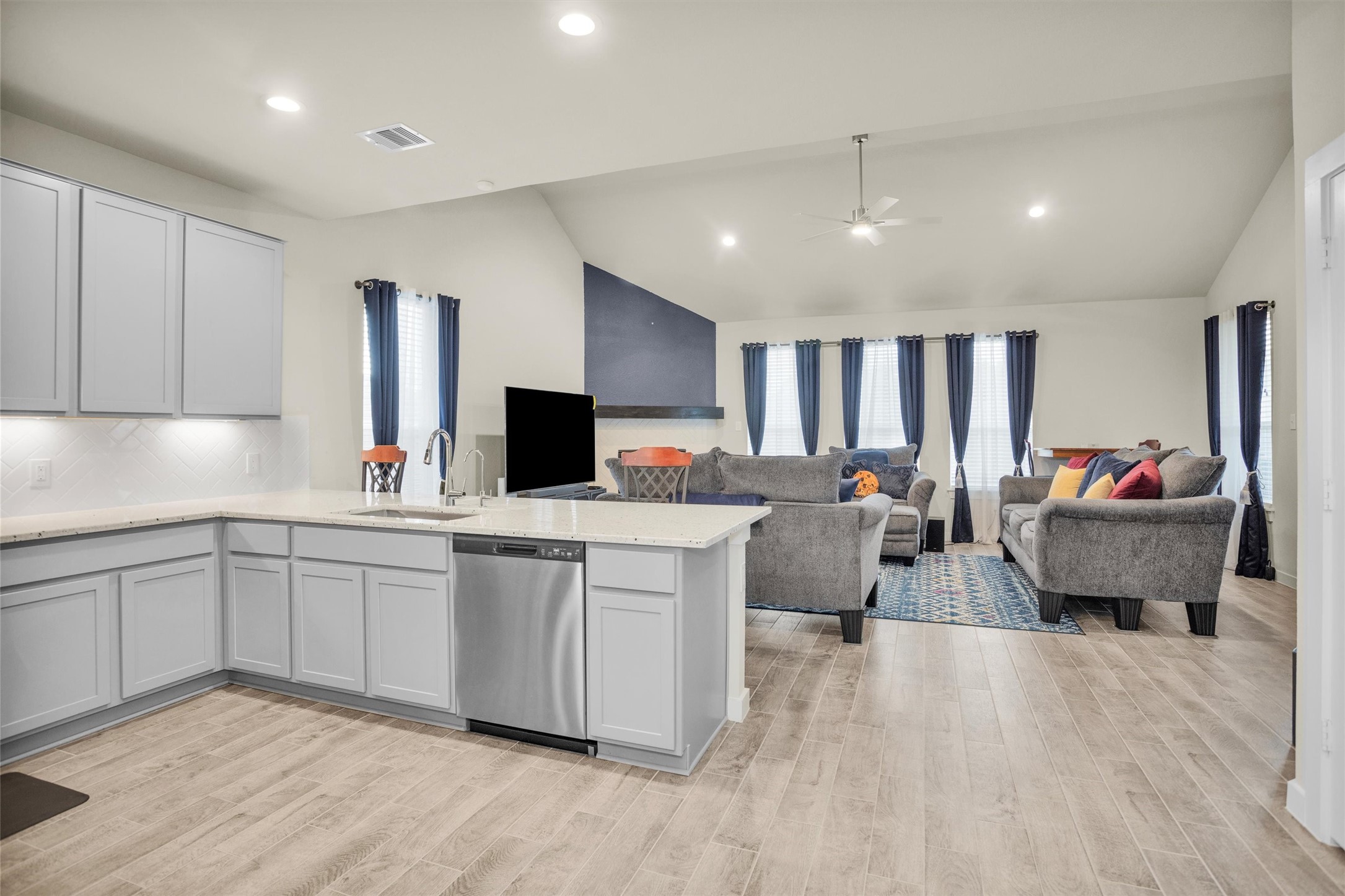 2210 Reed Cave Ln Spring Spring, TX 77386 - Photo 9 of 40 a large white kitchen with stainless steel appliances granite countertop a sink dishwasher a stove and a refrigerator with wooden floor