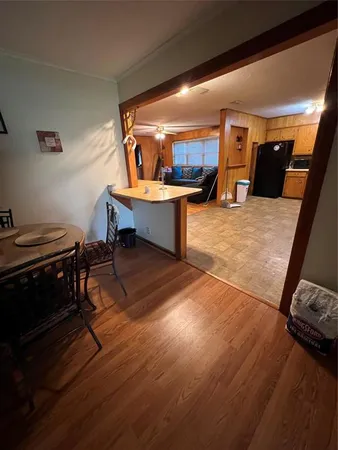 a living room with furniture a wooden floor and a sink