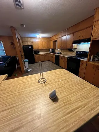 a kitchen with a sink stainless steel appliances and view kitchen