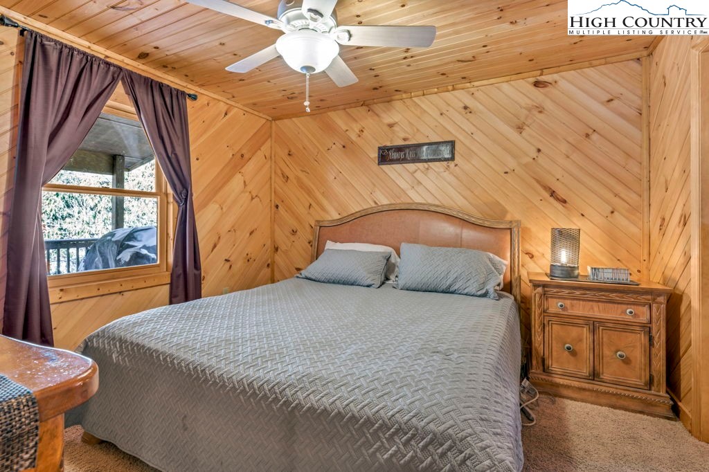 173 Spring Brook Road Newland, NC 28657 - Photo 16 of 39 a large bed sitting in a bedroom next to a window