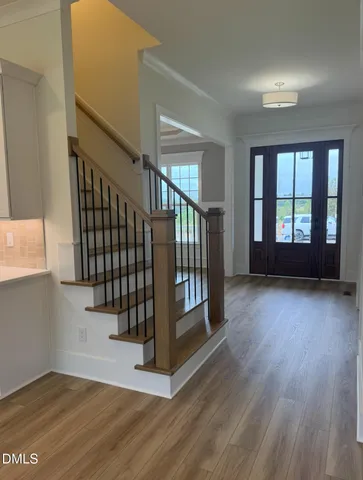 a view of an entryway with wooden floor