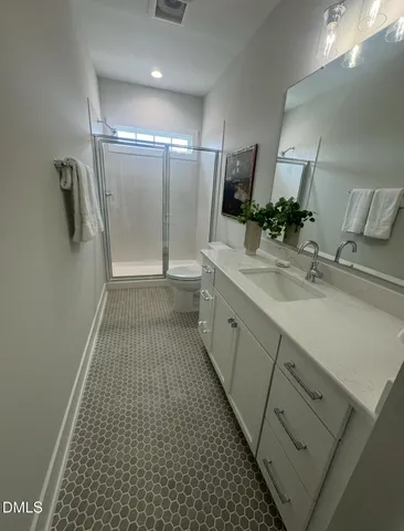a bathroom with a sink a large mirror and a shower