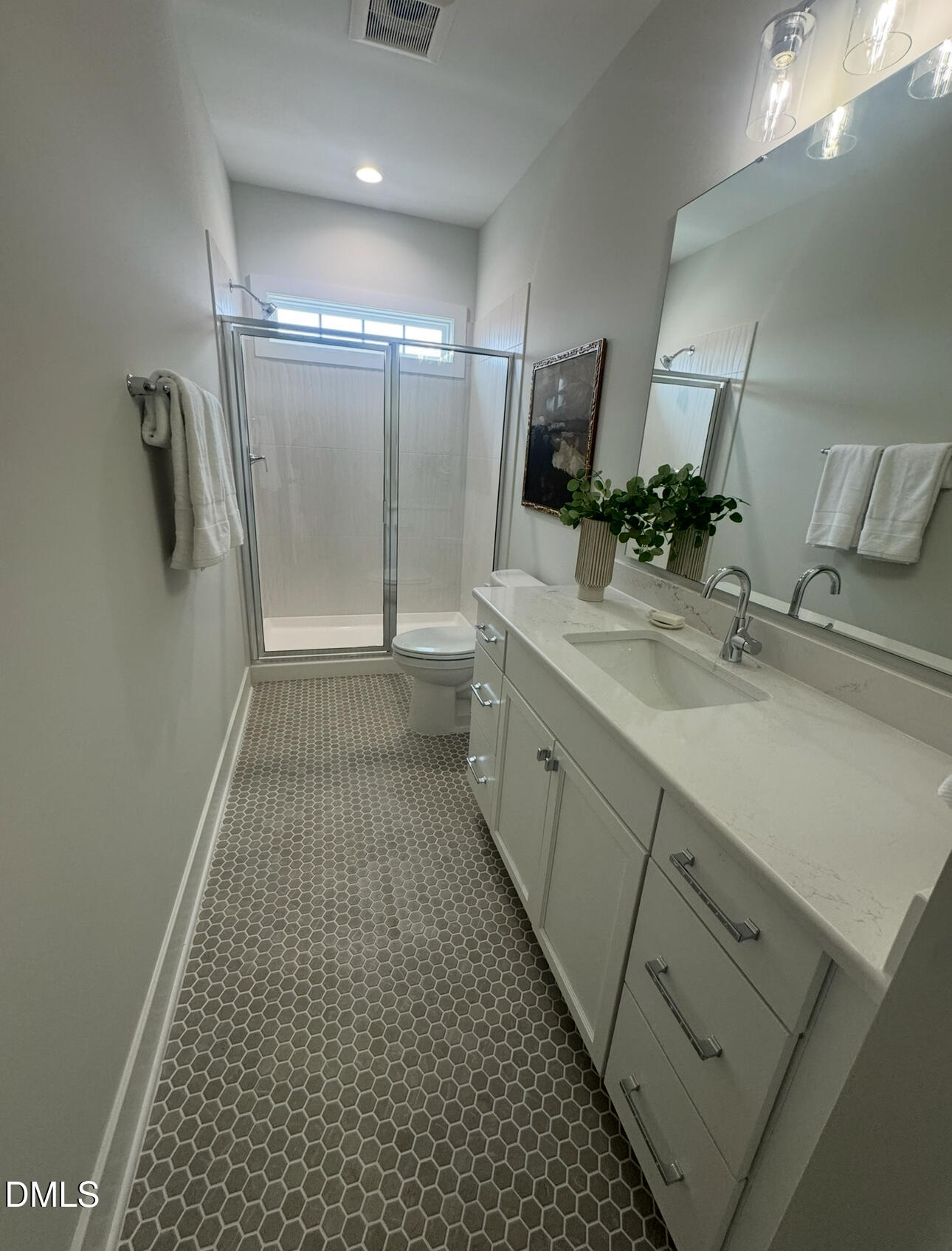 1037 Azalea Garden Circle Raleigh, NC 27603 - Photo 23 of 24 a bathroom with a sink a large mirror and a shower