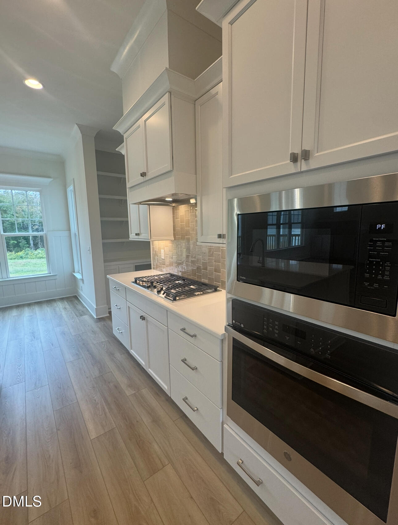 1037 Azalea Garden Circle Raleigh, NC 27603 - Photo 4 of 24 a kitchen with granite countertop white cabinets and appliances