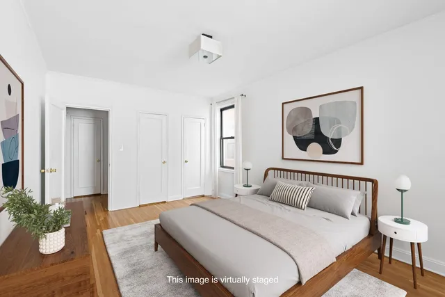 a bedroom with bed and wooden floor