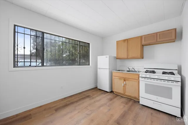 a kitchen with a stove a sink and a microwave