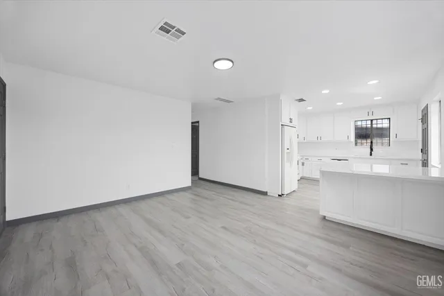 a view of kitchen with wooden floor and electronic appliances