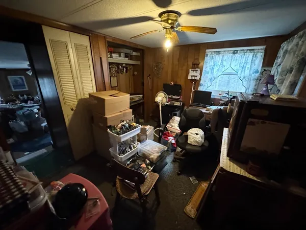 a bedroom with furniture and a lamp