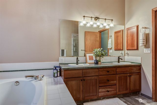 a bathroom with a double vanity sink and a mirror