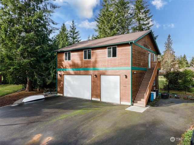 a view of a house with a yard and garage